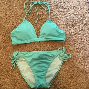 Aqua blue swim suit. Barely worn. Adjustable tabs in bottom.